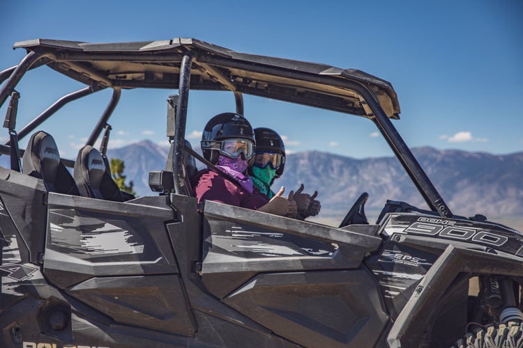 Off-road riders driving side-by-side ATV